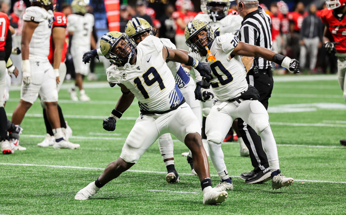 Thomas County Central's Walter Reddick (19) and Caleb Anderson (20) celebrate another big play by the Yellow Jackets roster. The two combined for 2-1/2 of the team's 10 sacks. 12/12/2023